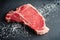 Raw T-Bone Steak with Kosher Salt and Black Peppercorns