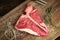 Raw t bone steak on wooden Board rustic style