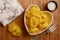 Raw tagliatelle in a heart shaped bowl