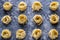 Raw tagliatelle nido on the flour-dusted black wooden background