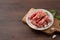 Raw Taiwanese sausage in garlic flavor in a plate on wooden table background