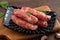 Raw Taiwanese sausage in garlic flavor in a plate on wooden table background