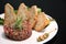 Raw tartar meat with spices, croutons and herbs. Beef tartar with capers. Beef tartar with slices of bread.