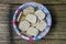 raw tempeh which is being soaked in water in a bowl that has been seasoned with salt and garlic.