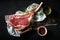 Raw tomahawk steak with spices and rosemary sprig