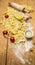 Raw tomatoes and pasta with flour, eggs and salt wooden rustic background top view close up