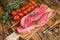 Raw top sirloin cap or picanha steak on a chopping Board. wooden background. Top view