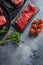 Raw tri tip,bottom sirloin, or tri-tip, triangle  roastcut black angus organic  steak on a black plate and stone slate with