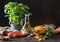 Raw tricolor fusilli pasta in glass bowl with oil and garlic, basil plant and tomatoes on wooden background