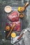 Raw tuna fish steak marinating with oil,lemon and rub brush on cutting board , top view