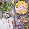 Raw turkey breast with potato, pear, red onion and herbs, with a variety of condiments, vintage knife for meat, on granite rusti