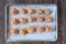 Raw turkey mixture meatballs on a parchment paper lined baking tray, ready for baking