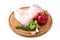Raw turkey wing, part of chicken poultry carcass, on a wooden round board with pepper and rosemary on a white background, isolate