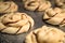 Raw unbaked dough chocolate babka twist danish buns with chocolate on a pan abstract close up with bohkeh