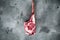 Raw uncooked black angus beef tomahawk steak on bone, on gray stone background, top view flat lay, with copy space for text