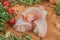 Raw uncooked chicken legs, drumsticks on a wooden board, meat with ingredients for cooking.