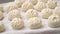 Raw uncooked meat buns on white table, homemade food, focus on foreground