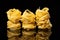 Raw uncooked tagliatelle nests on black background with reflection. Traditional Italian pasta