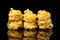 Raw uncooked tagliatelle nests on black background with reflection. Traditional Italian pasta