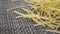 Raw uncooked thin vermicelli on a kitchen plastic texture mat.