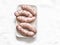 Raw uncooked turkey homemade sausages on light background, top view. Food ingredient