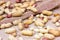 Raw unpeeled peanut nuts in nutshell on light beige textile background.