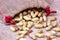 Raw unpeeled peanut nuts in nutshell on light beige textile bag background.