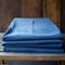 Raw And Unpolished: Denim Plain Sheet Stacked On Wooden Chair