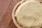 Raw unprepared semolina in wooden bowl.