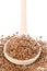 Raw, unprocessed linseed or flax seed in wooden spoon