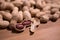 Raw unshelled peanuts close up on natural wooden background shallow depth of field