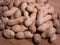 Raw unshelled peanuts close up on natural wooden background shallow depth of field