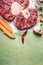 Raw veal shank meat and ingredients for Osso Buco cooking on rustic background, top view