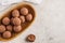 Raw vegan balls from nuts and cocoa in a wooden bowl, top view,