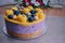 Raw vegan blueberry cake decorated with berry. Mango filling jelly vegetarian cashew cream cheesecake gluten free