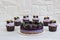 Raw vegan cake with blackberries and blueberries. Delicious cupcakes with lilac cream with blackberries and rosemary. Healthy