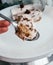 Raw vegan coco choco dessert on spoon. Coconut chocolate filling vegetarian cashew cream cheesecake gluten free. Lactose