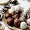 Raw vegan coconut chocolate candy balls over white with eucalyptus branches