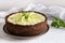 Raw vegan lime cheesecake with pepper mint on white background, close up