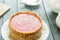 Raw Vegan Paleo Diet Berry Cheesecake Gluten-Free with Dates and Cashews on a Dark Grey Wooden Background, Horizontal