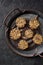 Raw vegan sweets. Homemade flax seed cookies in metal tray on dark background top view