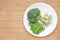 Raw of vegetables baby food broccoli and sweet pea in white plate with frozen mashed baby food homemade in white ceramic bowl on