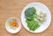 Raw of vegetables baby food broccoli and sweet pea in white plate with frozen mashed baby food homemade in white ceramic bowl on