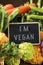 Raw vegetables and text I am vegan