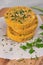 Raw veggie burger with chickpeas, vegetables and parsley leaves on kitchen countertop