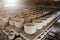 Raw vintage style kaolin cups or China clay cups are arranged in rows on the shelf.