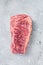 Raw Wagyu striploin or New york steak on a butcher table. Gray background. Top view
