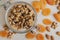 Raw walnut in glass container, dried apricot and almond