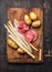 Raw white asparagus with veal meat fillet and potatoes, preparation on rustic wooden cutting board, tradition german food