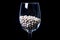 raw white beans in glass jar, wine glass. in bucket. raw white beans on black background. front view raw white beans, dropped from